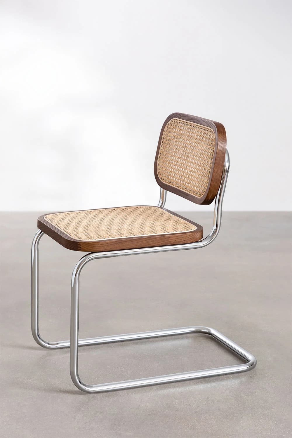 A modern cantilever chair with a tubular chrome frame and a seat and backrest made of wood with cane webbing. The chair has a distinct industrial design aesthetic. — 3D model