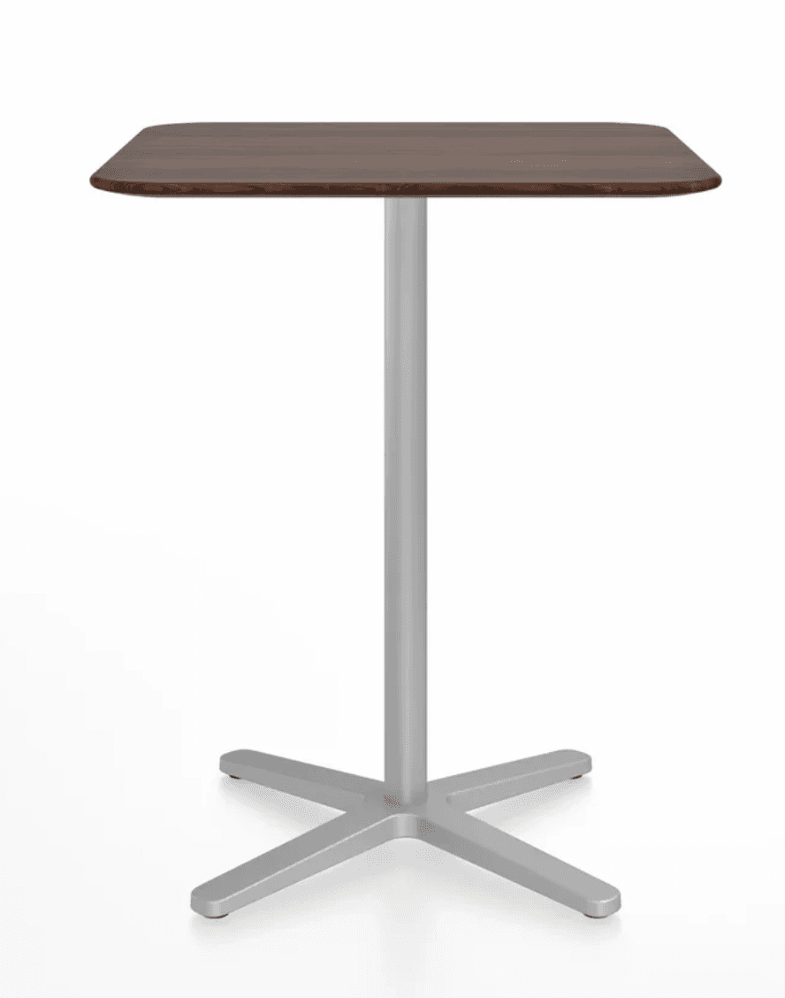 A modern square-top table with rounded corners, featuring a dark wood grain finish, supported by a single cylindrical silver metal pedestal and a four-pronged star-shaped metal base. — 3D model