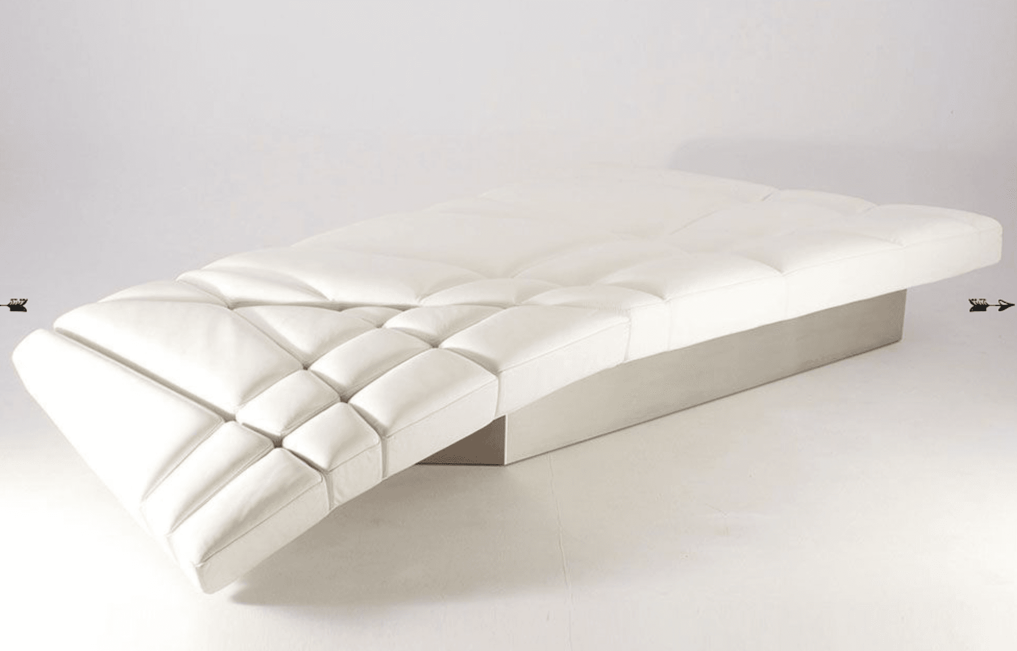 A modern white chaise lounge with a tufted, segmented seating surface. The base appears to be a solid, low-profile structure in a neutral metallic or wood finish. — 3D model