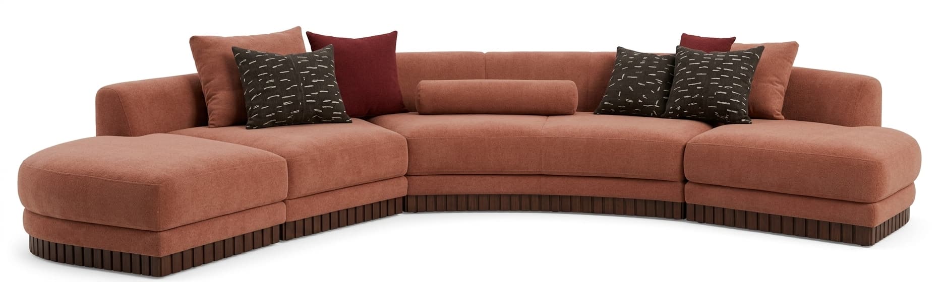 A large, contemporary curved modular sectional sofa upholstered in a warm terracotta or reddish-brown boucle-like fabric, featuring multiple sections including an ottoman-like end piece and a distinctive dark wood fluted base. Several accent pillows in varying shades and patterns are included. — 3D model