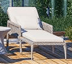 An outdoor chaise lounge featuring a light-colored woven synthetic frame and thick, plush cushions in a matching off-white hue. The backrest appears to be adjustable, and the lounge is supported by four tapered legs. — 3D model