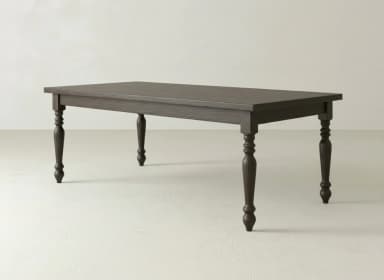 A rectangular dining table with a dark charcoal gray finish, featuring a smooth tabletop and four classic turned legs. The table appears to be made of solid wood, with a visible wood grain under the finish. — 3D model