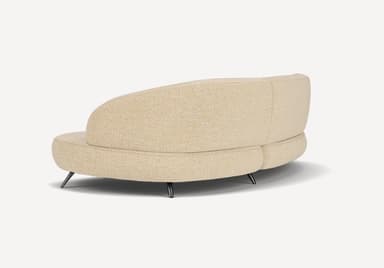 A modern curved sectional sofa, upholstered in a light beige or cream textured fabric, featuring a flowing, organic form and supported by slender, angled dark metal legs. — 3D model