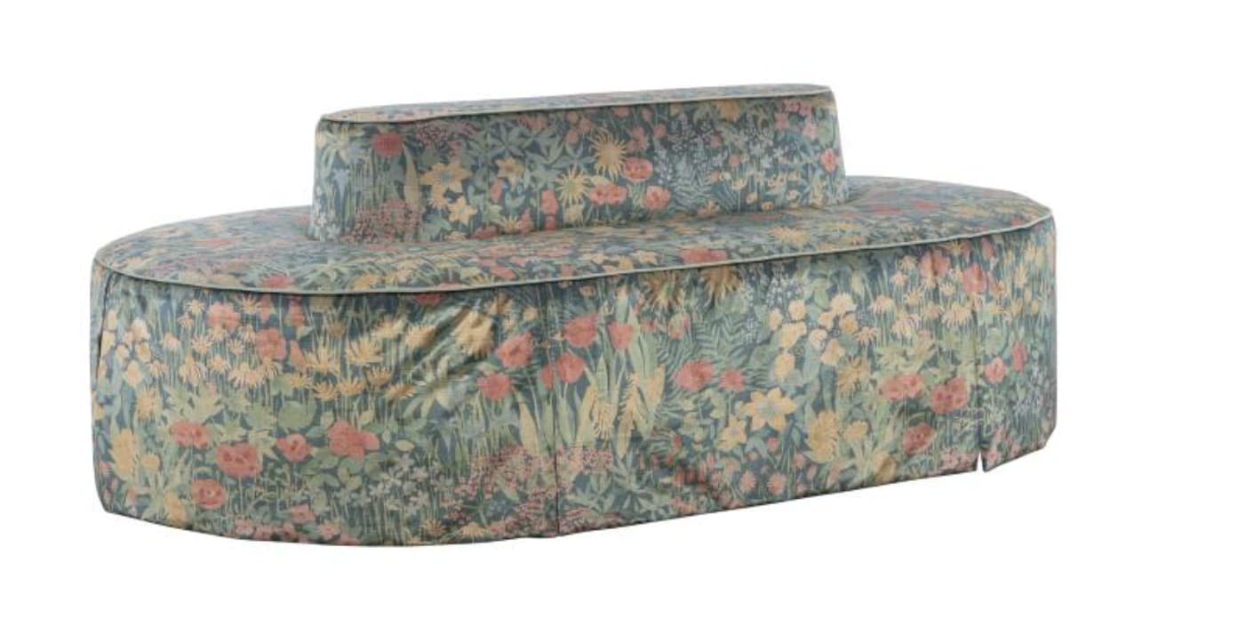 An oval-shaped, double-sided settee featuring a low, central backrest, allowing seating from either side. It is fully upholstered in a rich, multi-colored floral fabric, primarily featuring various shades of green, pink, yellow, and blue on a dark green background. The base is completely covered by a pleated fabric skirt, and the overall form is rounded and contemporary while the upholstery pattern has a classic botanical aesthetic. — 3D model