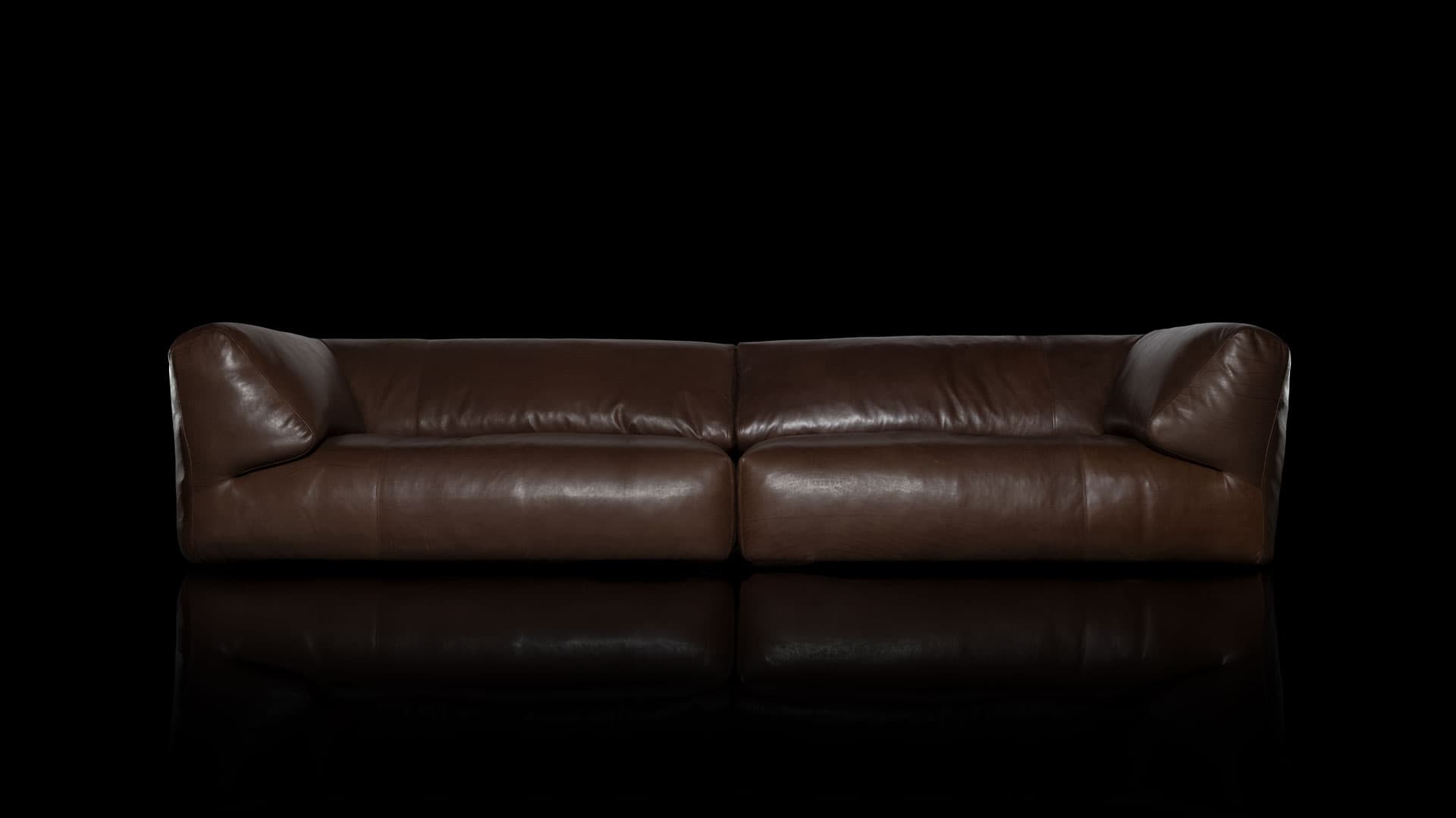 A contemporary brown leather sofa, characterized by its low-profile design and generously padded, inward-sloping arms. The seating features two large, plush cushions, suggesting a comfortable and relaxed seating experience. The leather exhibits a slightly worn, supple texture, hinting at quality material. — 3D model