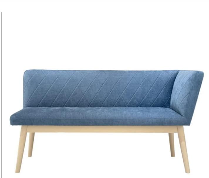 An upholstered bench featuring a single angled armrest on the right side and a backrest, both adorned with diamond tufting. The seat is also upholstered. It is supported by four light-colored, tapered wooden legs. — 3D model
