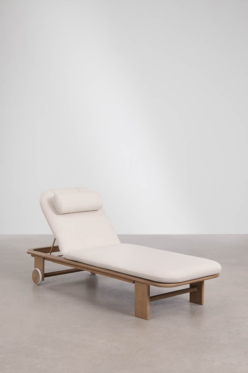 A modern outdoor chaise lounge featuring a sturdy light-toned wooden frame and a thick, cream-colored upholstered cushion. The backrest is adjustable, and the lounge is equipped with wheels at one end for easy mobility. A small, matching head pillow is attached to the adjustable backrest. — 3D model