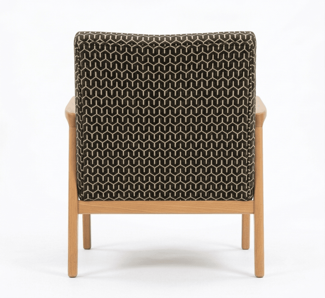 An armchair featuring a light wood frame with exposed armrests and legs, and a backrest upholstered in a black and tan geometric patterned fabric. The image shows the chair from the rear. — 3D model