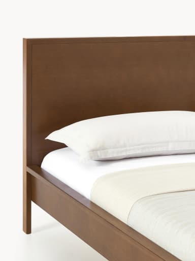 A modern platform bed featuring a clean, minimalist design crafted from dark-stained wood. It includes a solid, rectangular panel headboard and a low-profile frame with integrated legs, designed to support a mattress without the need for a box spring. The bed frame exhibits a smooth, finished surface. — 3D model