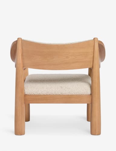 A modern armchair with a solid wood frame and upholstered seat and backrest. The frame features rounded, tapered legs and armrests, with curved supports for the back. The upholstery appears to be a textured boucle fabric. — 3D model