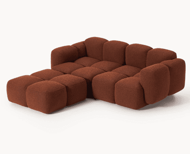 A modular sofa with a rounded, organic silhouette. The sofa is composed of several individual cubic modules that are upholstered in a textured, bouclé fabric. The arrangement suggests a sectional configuration, possibly an L-shape, with distinct seat and backrest sections, and padded armrests. The overall design is characterized by its plush, pillow-like appearance and low profile. — 3D model