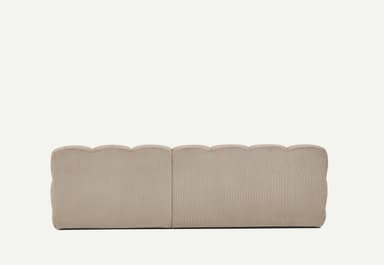 A light beige, modular sectional sofa featuring a chaise lounge component on the right side. The entire sofa is upholstered in a ribbed corduroy fabric, giving it a plush, textured appearance. It consists of deep, blocky cushions for both the seat and backrest, arranged in a low-profile, contemporary style. The armrests are similarly upholstered and integrated, providing a soft, rounded look. — 3D model