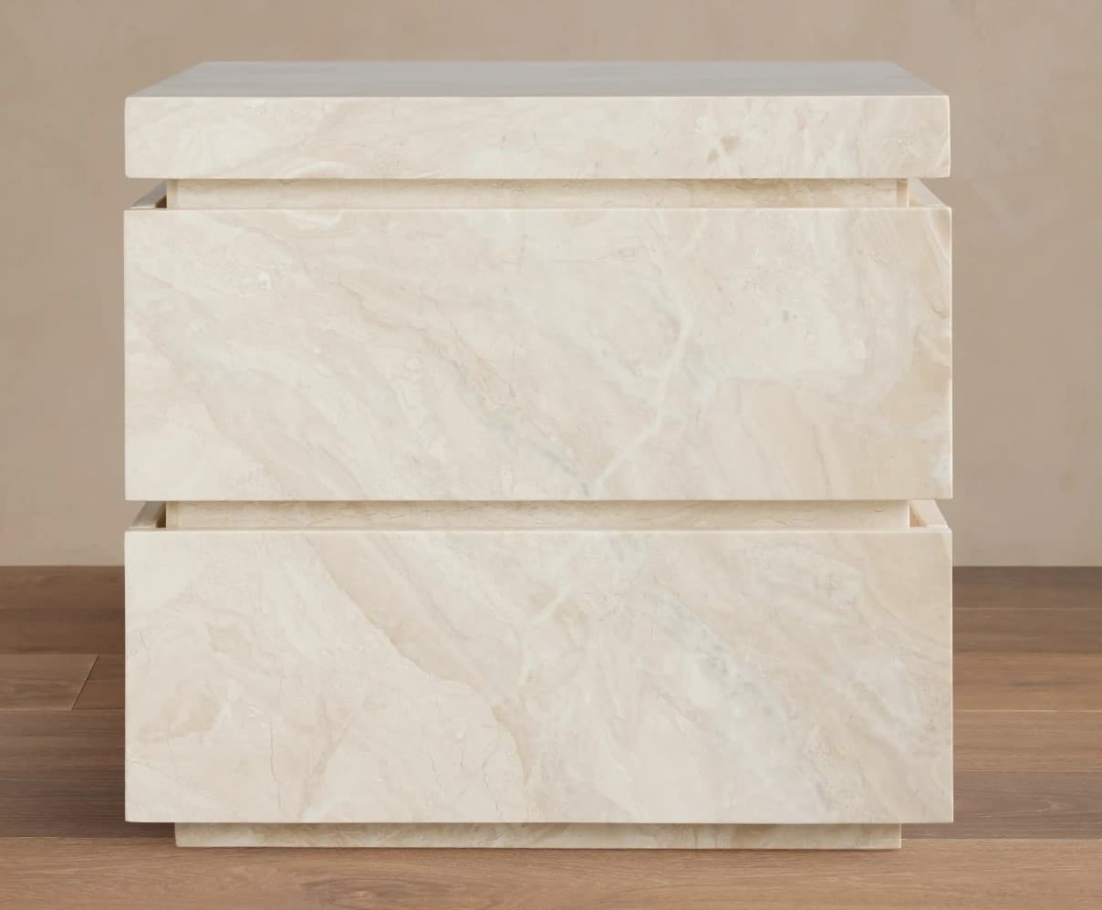 A two-drawer nightstand constructed from a light-colored stone with prominent veining. The design features a stacked, rectilinear form with inset drawer fronts and a slightly overhanging top. The finish appears smooth and polished. — 3D model