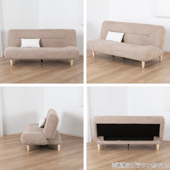 A compact, two-seater sofa bed upholstered in a light beige fabric, featuring clean lines and a modern aesthetic. It has a single, subtle horizontal tuft detail on the backrest. The sofa is supported by four light-colored, tapered wooden legs, indicating a minimalist or Scandinavian influence. A small white rectangular pillow rests on the seat. — 3D model
