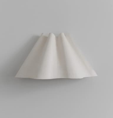 A contemporary pendant light featuring a folded or pleated shade. The shade appears to be made of a translucent material, possibly glass or resin, with a matte white finish. The pleats create a dynamic, organic form that diffuses light softly. The base, where the shade attaches to the suspension system, is not visible in this image, but the overall design suggests a modern, minimalist aesthetic. — 3D model