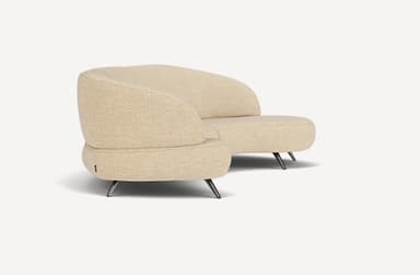 A modern curved sectional sofa, upholstered in a light beige or cream textured fabric, featuring a flowing, organic form and supported by slender, angled dark metal legs. — 3D model