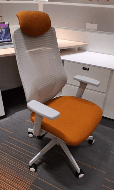 A white and orange ergonomic office chair featuring a high mesh backrest, an upholstered seat cushion, an upholstered headrest, adjustable white armrests, and a five-star base with casters for mobility. The chair combines functional design with a contemporary aesthetic. — 3D model