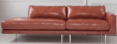 An L-shaped sectional sofa upholstered in a warm cognac brown leather, featuring clean lines and a modern aesthetic. It includes a spacious chaise lounge component and rests on slender, cylindrical metal legs. — 3D model