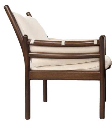 A dark-stained wooden armchair with a tall, slightly curved back and integrated armrests. The chair features upholstered cushions for the seat and back, rendered in a light, off-white fabric. The frame exhibits a minimalist design with slender legs and support structures, suggestive of mid-century modern aesthetics. — 3D model