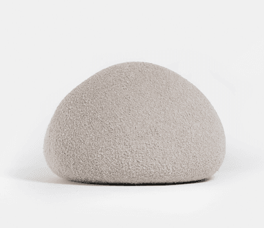 A light grey, upholstered, organically shaped piece of furniture, resembling a large smooth pebble or rock. Its surface appears to be a soft, textured fabric. — 3D model