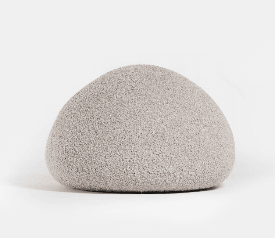 A light grey, upholstered, organically shaped piece of furniture, resembling a large smooth pebble or rock. Its surface appears to be a soft, textured fabric. — 3D model