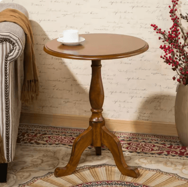 A small, round wooden table featuring a turned pedestal base and three curved, splayed legs. The tabletop has a subtle beveled edge and the entire piece is finished in a medium-to-dark brown wood tone, suggesting a traditional or transitional style. — 3D model