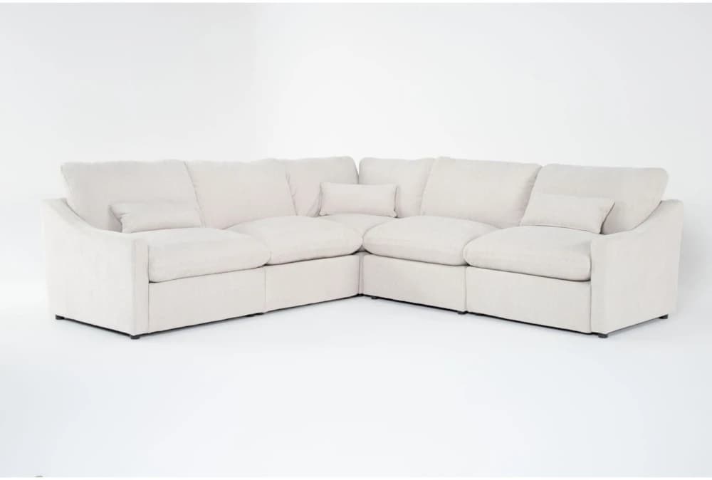 A cream-colored modular sectional sofa upholstered in a soft fabric, featuring plush cushions and a low-profile design, arranged in an L-shape. — 3D model