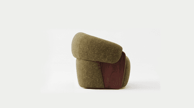 A modern lounge chair featuring a distinctive rounded and plush form, upholstered in a textured olive green fabric, with elegant dark wood panels integrated into the lower sides. — 3D model