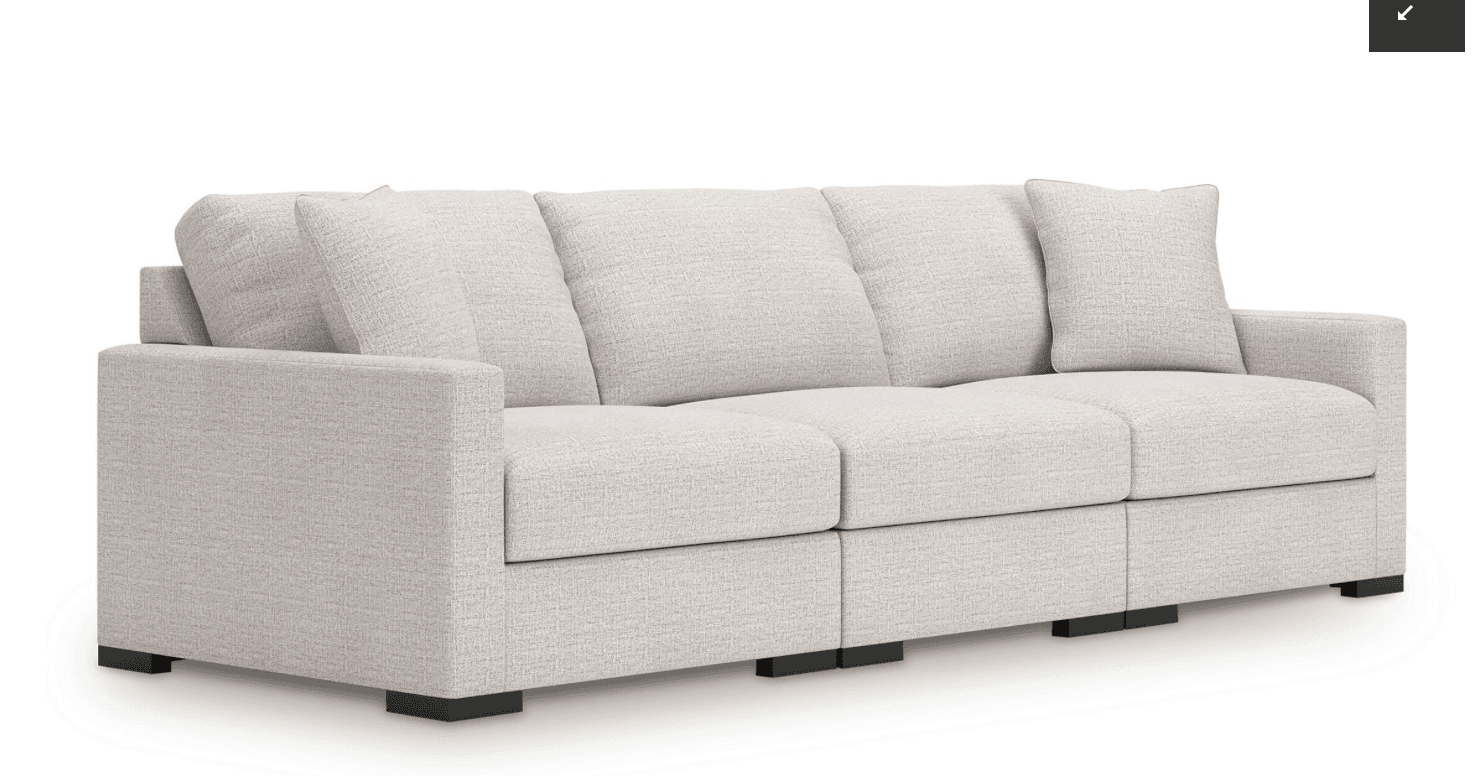 A contemporary three-seater modular sofa, upholstered in a light beige, subtly textured woven fabric. It features a clean, rectilinear design with track arms and low-profile block feet. The sofa is composed of three distinct modules, suggesting versatility in configuration. Both the seat and back cushions are loose and removable. — 3D model