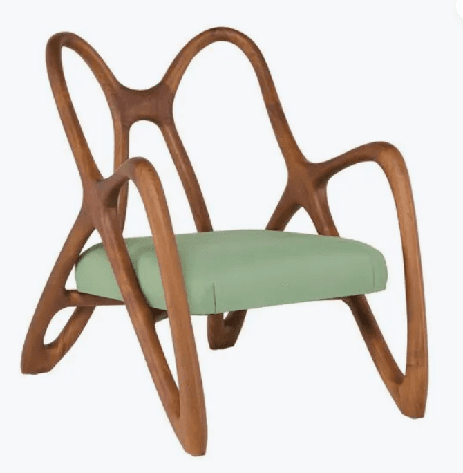 A sculptural lounge chair with a distinctive abstract form, crafted from bent wood. The chair features a curved, open-back design with flowing lines that create armrests and a unique structural base. A cushioned seat upholstered in a light green fabric provides contrast to the wooden frame. — 3D model