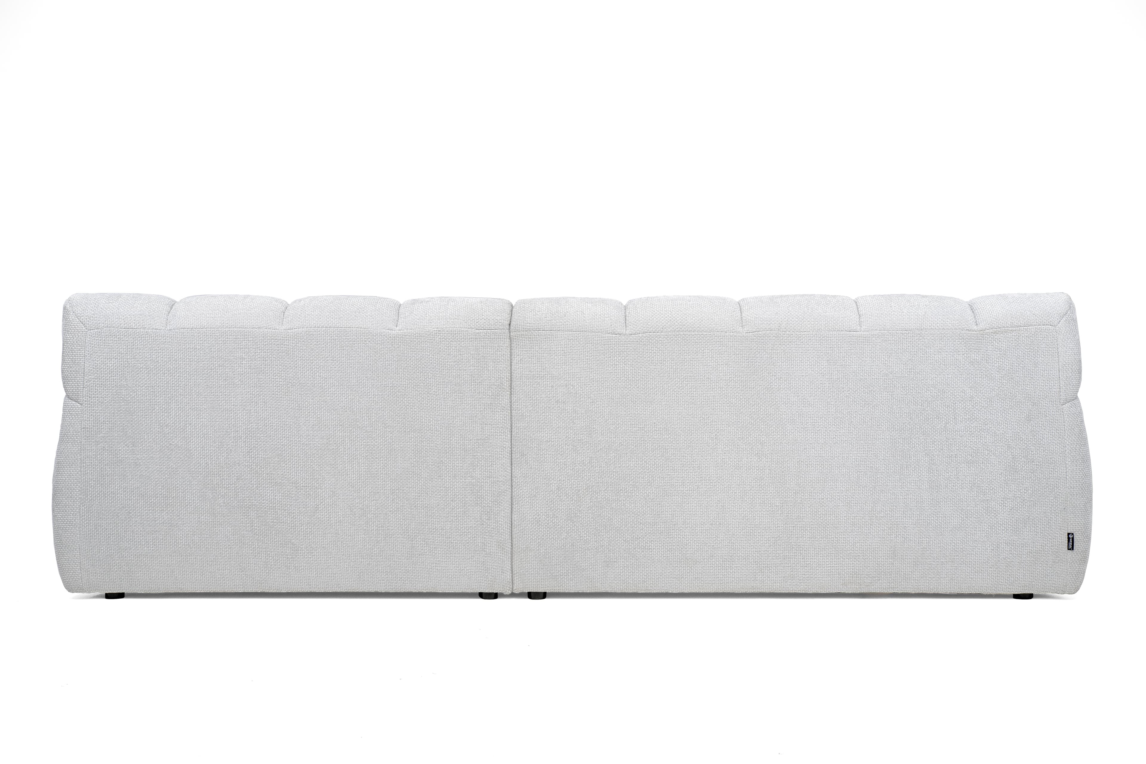 The image shows the back view of a contemporary sectional sofa module. It is upholstered in a light gray, subtly textured fabric. The backrest features horizontally segmented panels along the top, suggesting individual plush cushions or a channeled design. A clear vertical seam down the center indicates it is either a two-seater back or two joined modules. The base is low-profile with small, dark feet. — 3D model