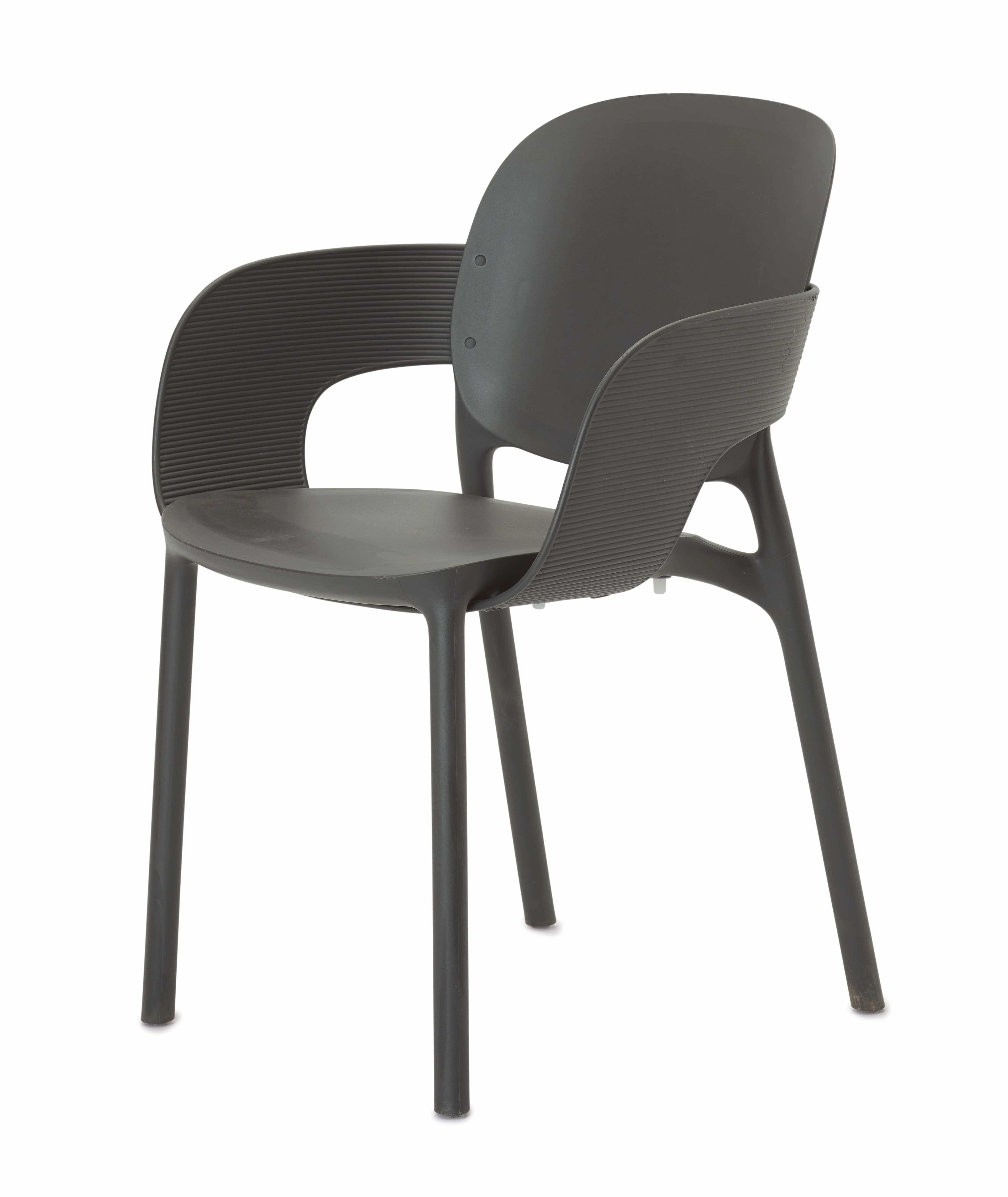 A contemporary dark gray armchair crafted from molded plastic, featuring a single-piece construction for the seat, backrest, and integrated armrests. The armrests and upper backrest display a fine ribbed texture, while the chair is supported by four sturdy, slender legs of the same material. — 3D model