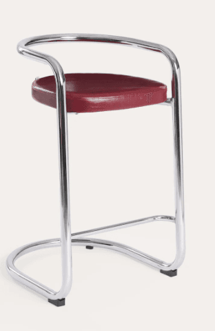 A modernist bar stool featuring a continuous chrome-plated tubular steel frame that forms the legs, footrest, and a curved backrest/armrest. It has a round seat upholstered in deep red material, resting on a stable cantilever-style base with black protective feet. — 3D model