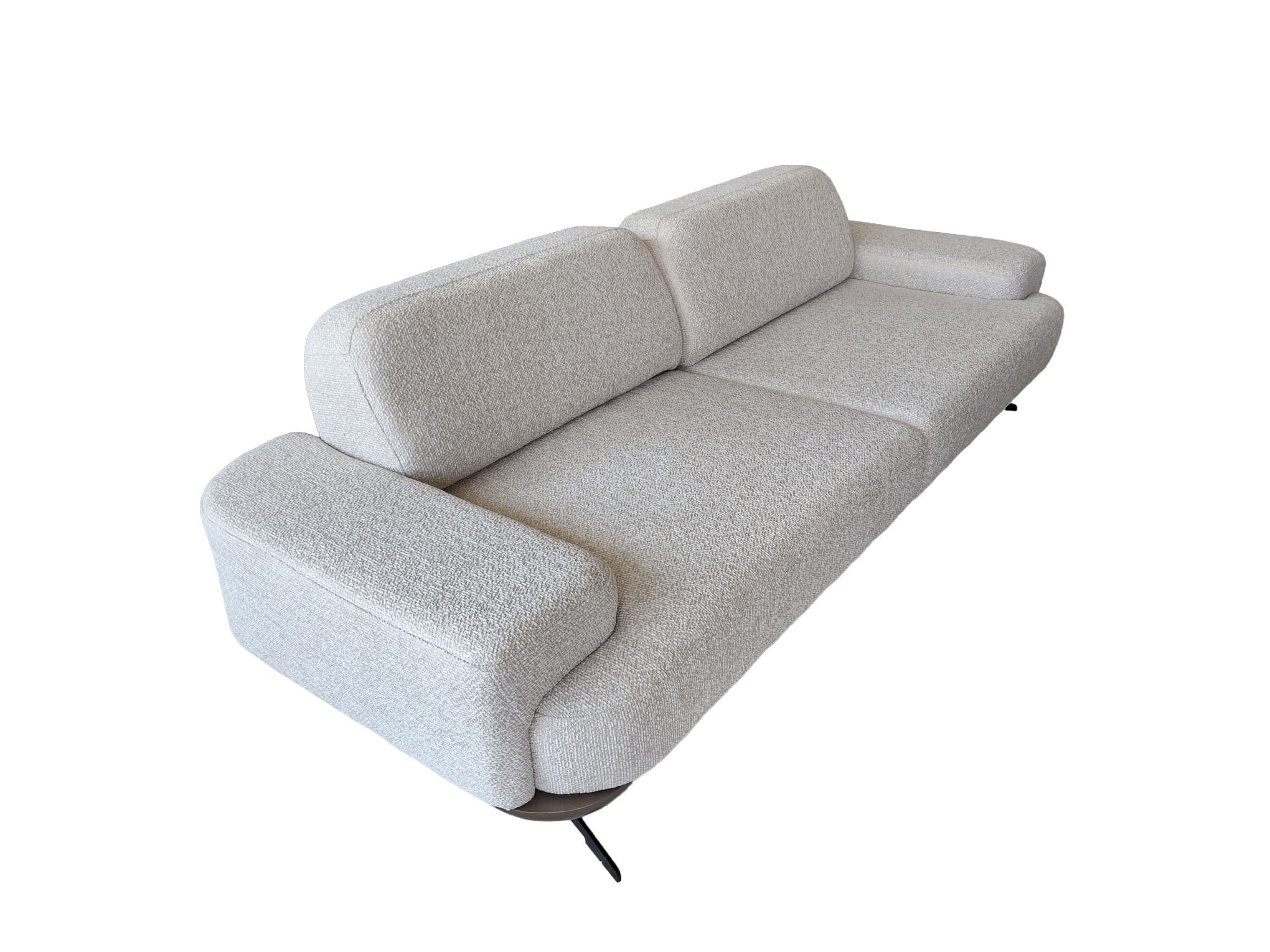 A contemporary two-seater sofa upholstered in a light-colored, textured fabric, featuring rounded armrests, individual back cushions, and subtle dark legs. — 3D model