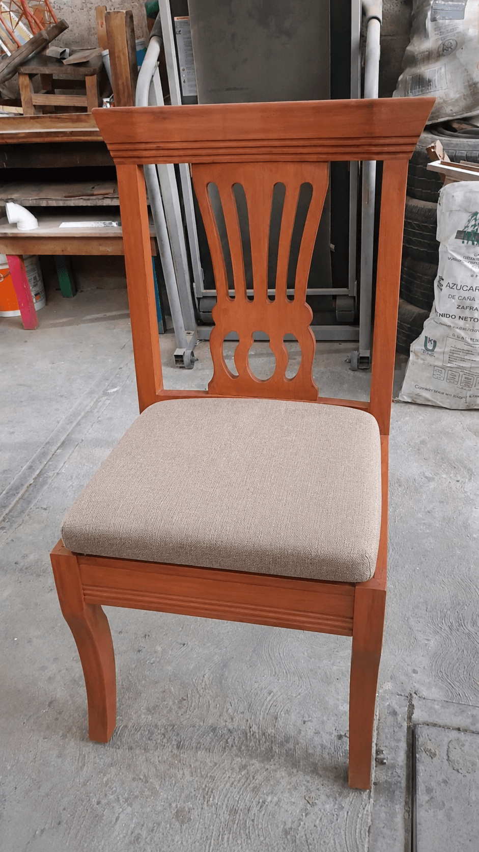 A traditional style armless dining chair featuring a decorative wooden backrest and a light-colored upholstered seat. — 3D model