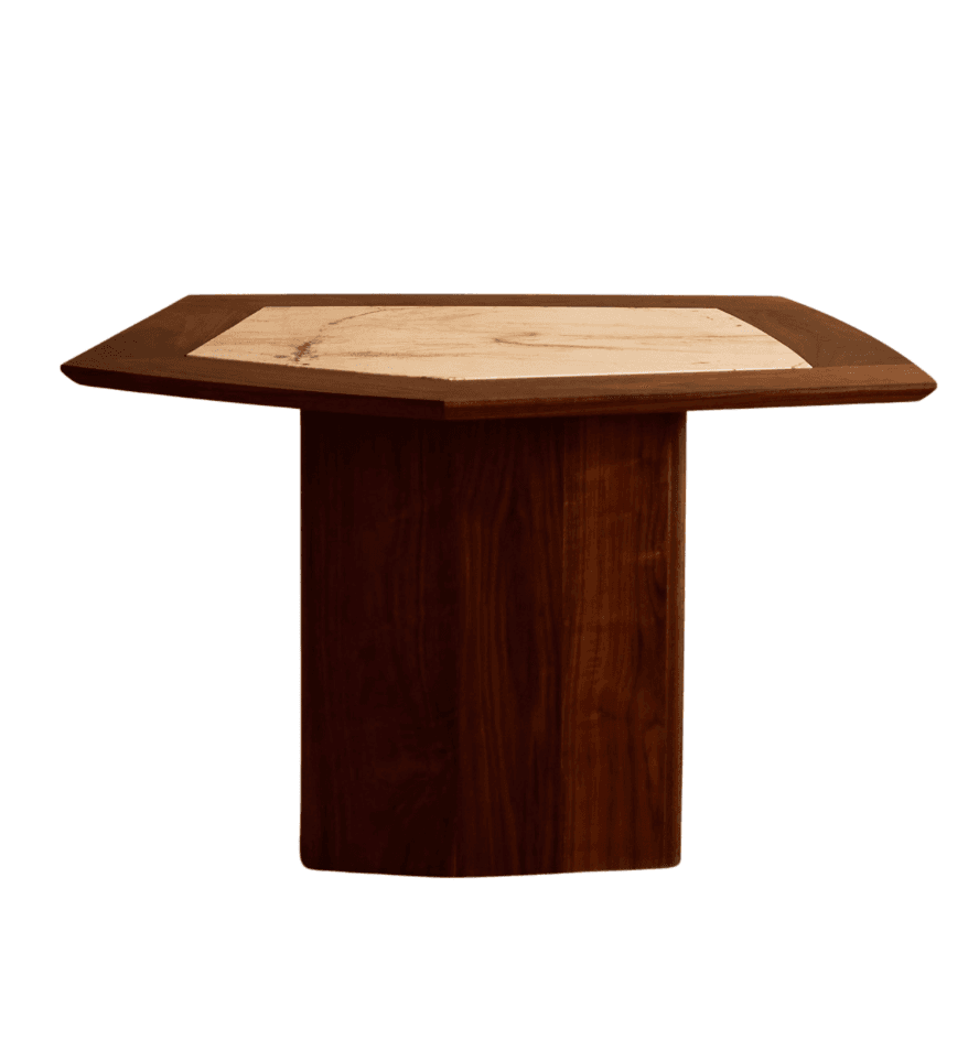 A dining table with a faceted pedestal base and a hexagonal tabletop. The tabletop features a central inset panel of patterned stone or marble, bordered by a dark wood frame. The pedestal base is constructed from dark wood planks with visible grain. — 3D model