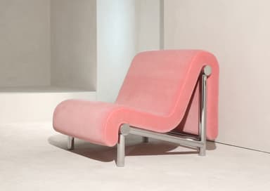 A postmodern lounge chair featuring an S-shaped upholstered form in pink velvet, supported by a polished chrome-plated metal frame. The design is contemporary with a distinct sculptural silhouette. — 3D model