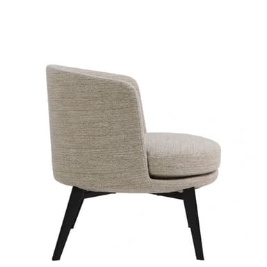 A contemporary armless accent chair with a low-profile design, upholstered in a light beige textured fabric. The chair features a rounded backrest that seamlessly blends into the seat, providing a bucket-like form. It is supported by four dark, tapered wooden legs. — 3D model