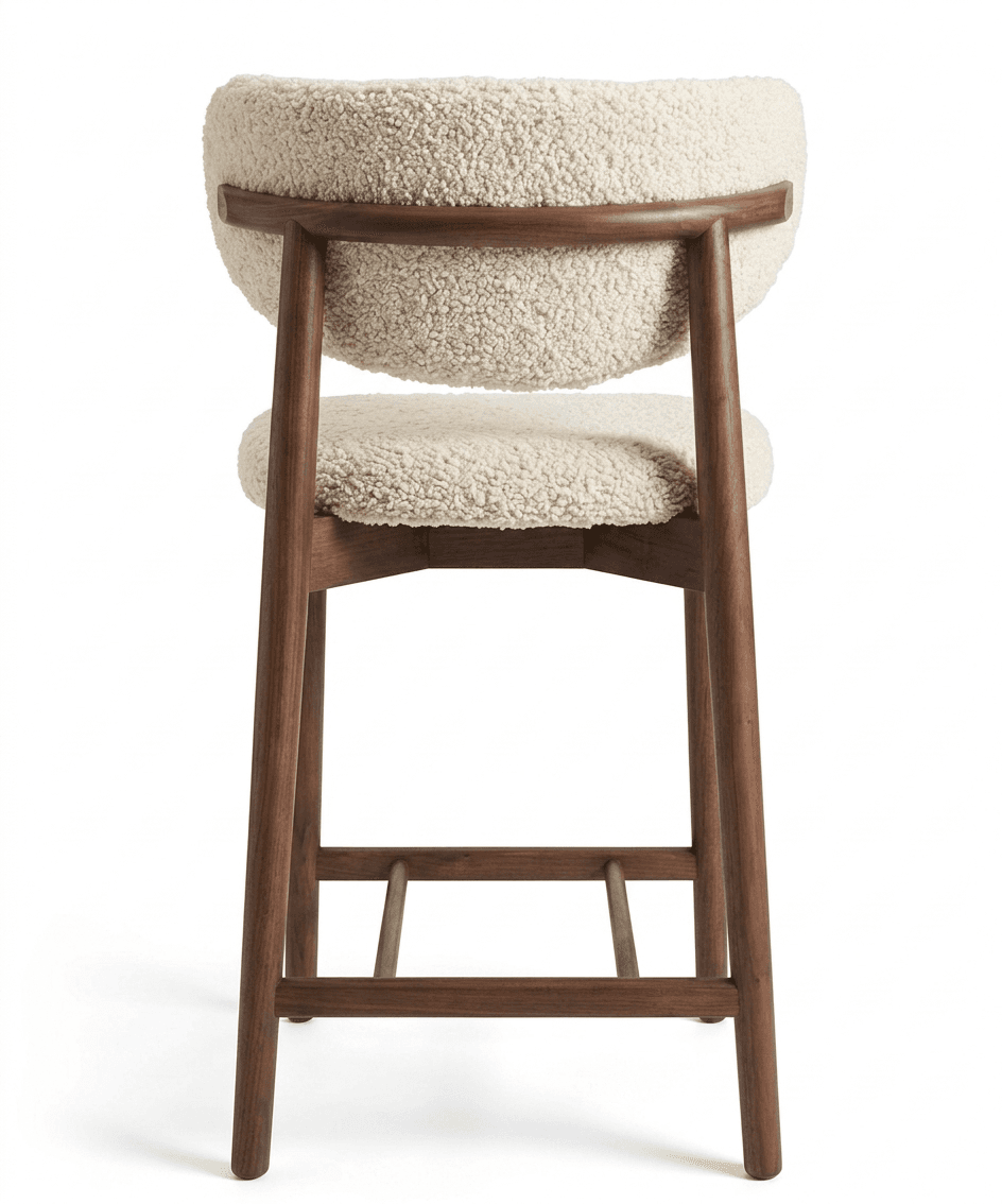 A bar stool with a curved backrest and a separate seat cushion. The frame and legs are made of dark wood, with a distinct grain. The upholstery on the backrest and seat appears to be a textured, plush fabric, possibly sherpa or a similar material, in an off-white or cream color. The stool features a wooden stretcher connecting the legs for stability. — 3D model