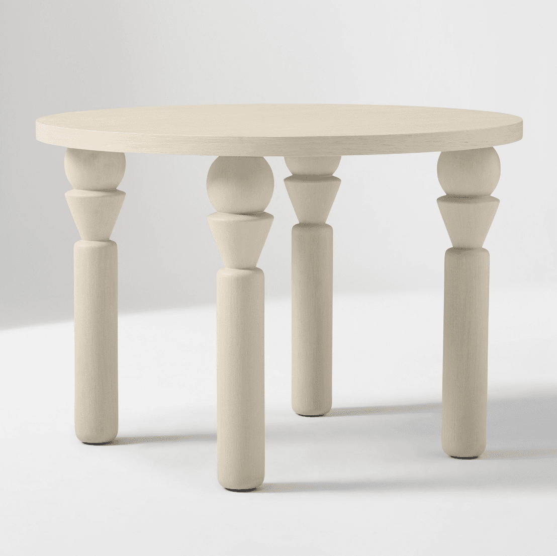 A light-colored round accent table with four sculptural turned wood legs. — 3D model