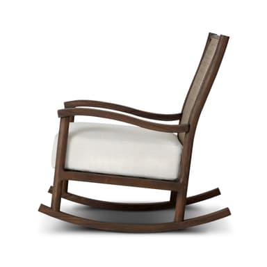 A rocking chair with a dark wood frame and woven cane back. The seat is upholstered in a white fabric. The chair has a classic rocking chair design with curved runners. — 3D model
