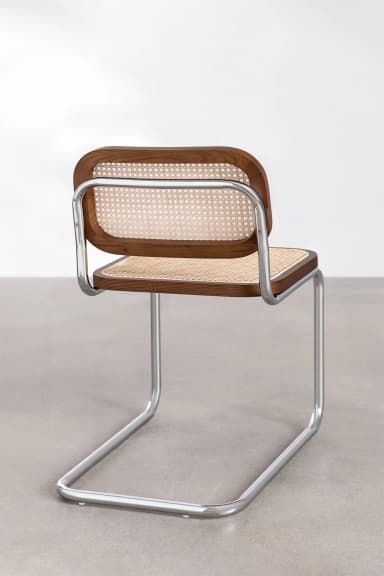 A modern cantilever chair with a tubular chrome frame and a seat and backrest made of wood with cane webbing. The chair has a distinct industrial design aesthetic. — 3D model