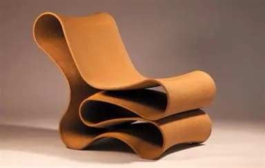 A highly sculptural lounge chair characterized by its continuous, ribbon-like form, creating an integrated seat and backrest. The design features undulating curves and appears to be self-supporting, rendered in a warm tan or camel-colored material with a soft, felted texture. — 3D model