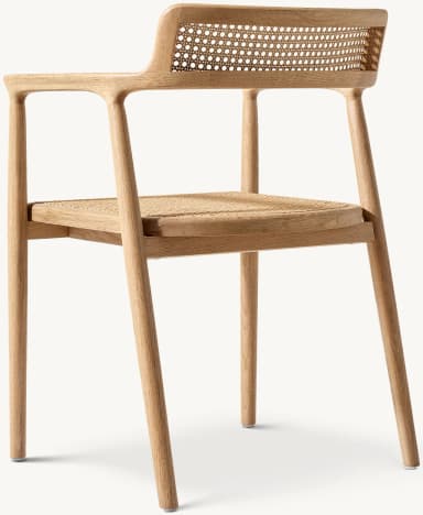 A modern dining armchair crafted from light-colored solid oak wood with natural cane weaving on both the backrest and the seat. The chair features a minimalist frame with rounded edges, integrated armrests that flow from the backrest, and four straight, tapered legs. — 3D model