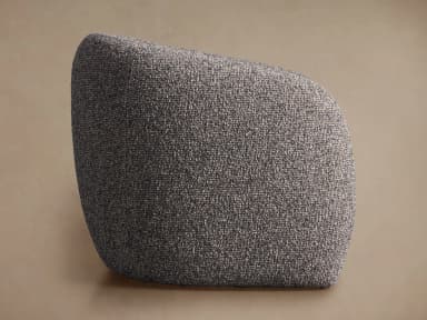 A generously proportioned armchair with a rounded, enveloping silhouette. The chair features a fully upholstered form with a high back that curves around to form integrated armrests. The upholstery has a textured, boucle-like appearance, creating a soft and inviting aesthetic. The base appears to be a continuous, rounded structure that extends to the floor, without visible legs. — 3D model