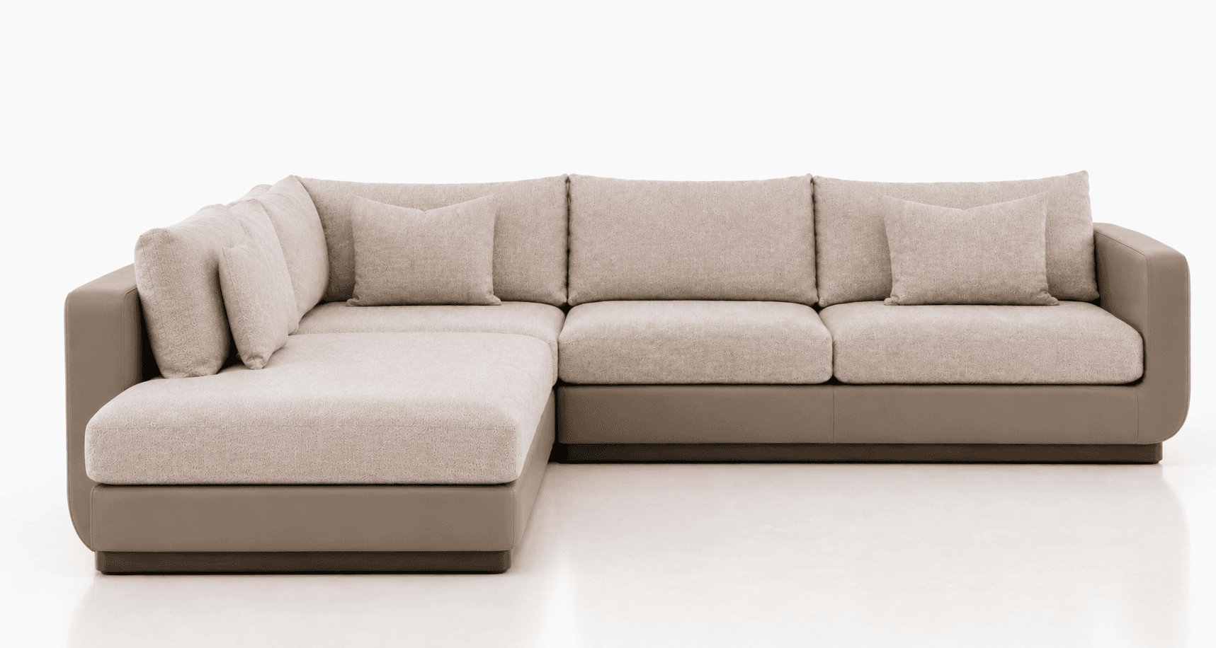 An L-shaped sectional sofa featuring a two-tone design. The base and broad, rounded arms are upholstered in a smooth, matte taupe material, likely leather or faux leather. The seat cushions, back cushions, and accent pillows are covered in a textured beige fabric with a subtle pattern. The configuration includes an extended chaise lounge on the left side, providing ample seating and reclining space. The overall aesthetic is clean, modern, and inviting, with a low profile and plush cushions. — 3D model