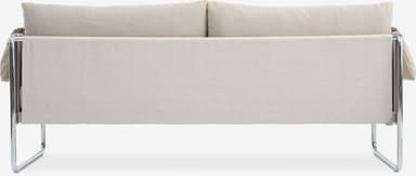 A close-up view of a sofa, focusing on the backrest and seat. The sofa features a tubular metal frame, likely chrome-plated steel, with a light-colored fabric upholstery. The backrest appears to be composed of two cushions, while the seat is a single upholstered panel. The overall design suggests a modern or Bauhaus-inspired aesthetic. — 3D model
