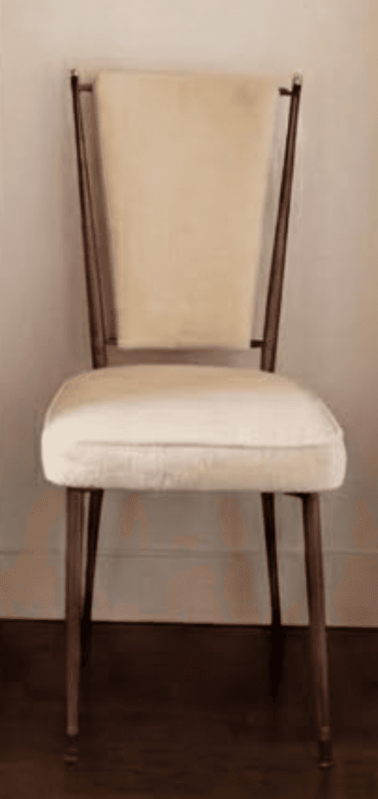 A dining chair with a wooden frame and upholstered seat and back. The frame is made of dark wood with a smooth finish. The seat and back are upholstered in a light-colored, textured fabric. The chair has four tapered legs that angle outwards, and the backrest is supported by two thin, vertical wooden supports that extend from the seat. — 3D model