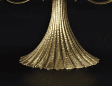 A decorative table base with a fluted, flared design reminiscent of a shell or a classical column pedestal. The top section is cylindrical with a subtle molding, transitioning into a series of vertical flutes that widen as they descend, culminating in a scalloped, petal-like edge. — 3D model