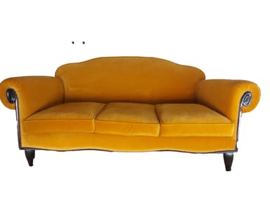 A traditional three-seater sofa upholstered in a rich golden yellow velvet fabric. It features prominent scrolled armrests, a gently curved backrest, and is adorned with decorative dark nailhead trim along the base and the exterior of the arms. The sofa is supported by four short, dark-finished, tapered wooden legs. — 3D model
